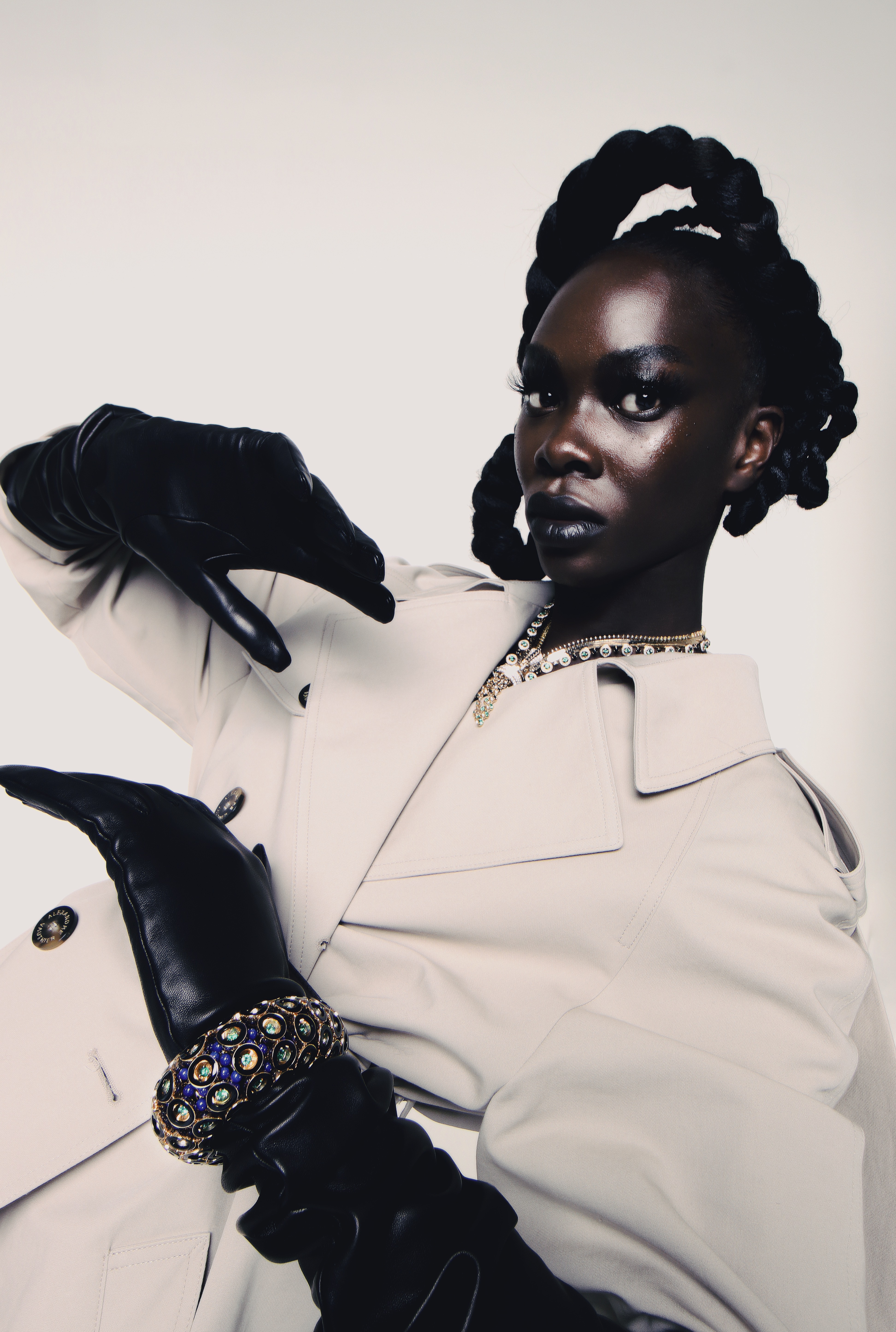High-fashion editorial styling with intricate braided updo and couture look